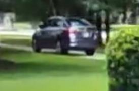 Photo of gray four-door sedan leaving the residence. 